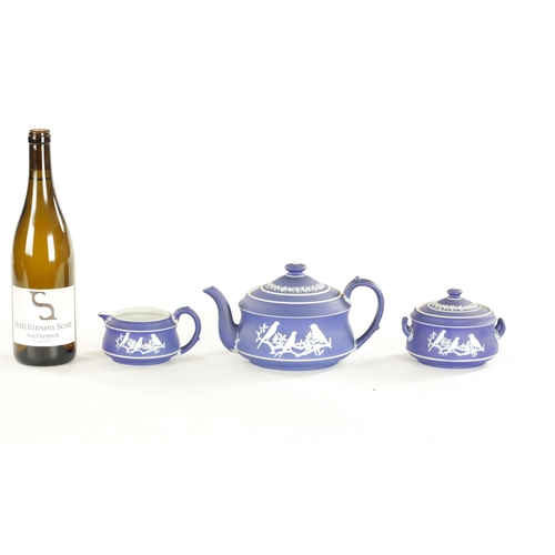 82 - A WEDGWOOD THREE-PIECE BIRD PATTERN TEASET comprising a teapot, sugar bowl and cream jug. (Teapot is... 