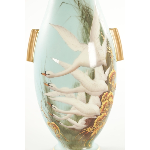 84 - AN EARLY 20TH CENTURY ROYAL WORCESTER CABINET VASE BY C. BALDWYN decorated with swans in flight on a... 