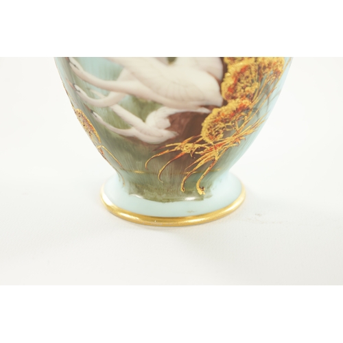 84 - AN EARLY 20TH CENTURY ROYAL WORCESTER CABINET VASE BY C. BALDWYN decorated with swans in flight on a... 