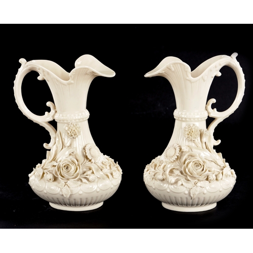 87 - A GOOD PAIR OF 19TH CENTURY BELLEEK, CO. FERMANAGH BLANC DI CHINE PORCELAIN EWERS the elegant ribbed... 