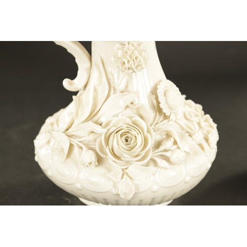 87 - A GOOD PAIR OF 19TH CENTURY BELLEEK, CO. FERMANAGH BLANC DI CHINE PORCELAIN EWERS the elegant ribbed... 