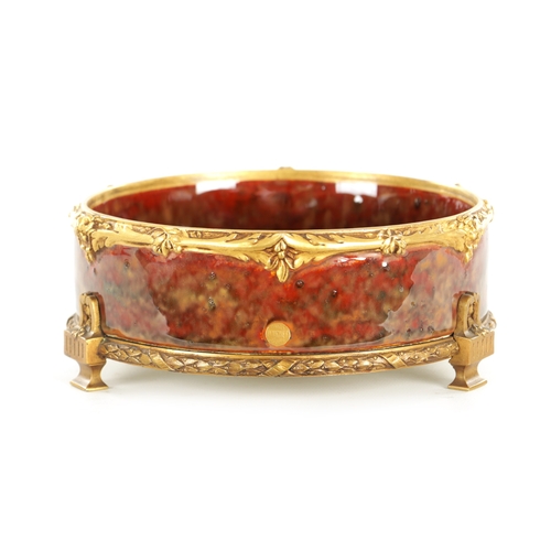 89 - LOUCHET A PARIS - A FRENCH ART NOUVEAU ORMOLU MOUNTED STONEWARE SHALLOW BOWL the high fired rouge mo... 