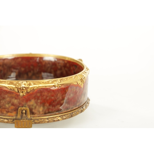 89 - LOUCHET A PARIS - A FRENCH ART NOUVEAU ORMOLU MOUNTED STONEWARE SHALLOW BOWL the high fired rouge mo... 