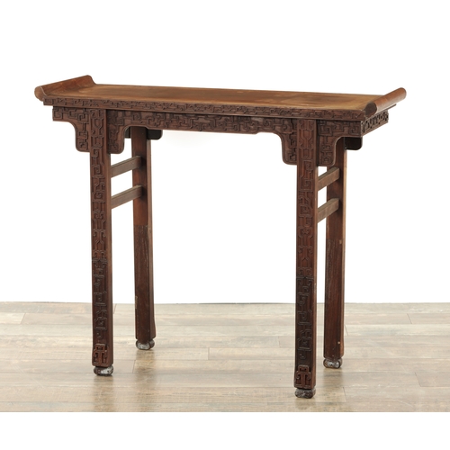 96 - A 19TH CENTURY CHINESE HARDWOOD ALTER TABLE with geometric blind carved designs to the fronts; raise... 