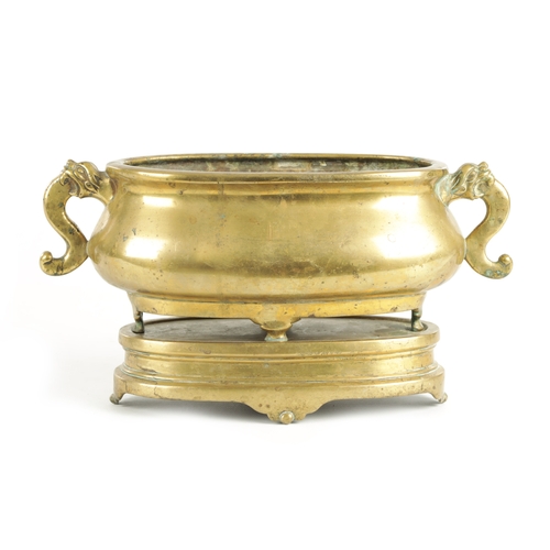 98 - AN EARLY GILT BRONZE CHINESE OVAL CENSER ON STAND with dog of foo side handles and shaped stand - bo... 