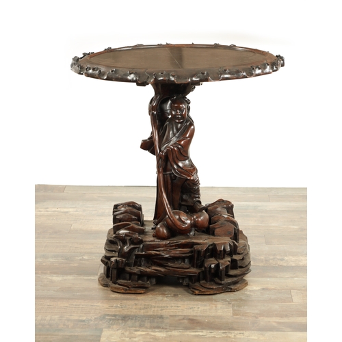 99 - A 19TH CENTURY CHINESE CARVED HARDWOOD CENTRE TABLE with a standing figure pedestal base having a bl... 