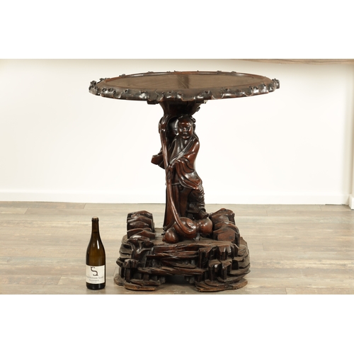 99 - A 19TH CENTURY CHINESE CARVED HARDWOOD CENTRE TABLE with a standing figure pedestal base having a bl... 