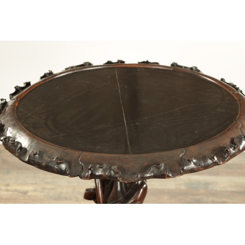 99 - A 19TH CENTURY CHINESE CARVED HARDWOOD CENTRE TABLE with a standing figure pedestal base having a bl... 
