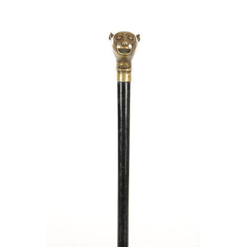 732 - A LATE 19TH CENTURY BRASS AND EBONY WALKING STICK with brass cast monkey head pommel (93cm overall )