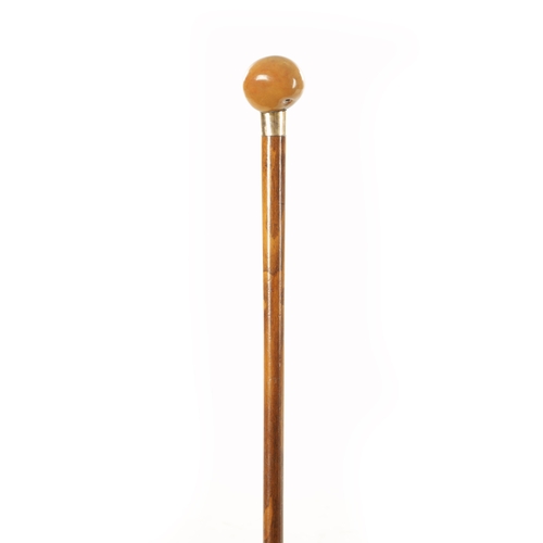 739 - A GOLD METAL MOUNTED SLENDER WALKING STICK STAMPED 'BRIGG' with a hardstone pommel handle. (94.5cm l... 