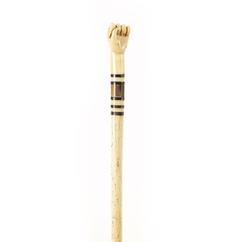 740 - A SHORT WHALEBONE WALKING STICK with ringed hardstone inset and clenched fist handle. (79cm long)