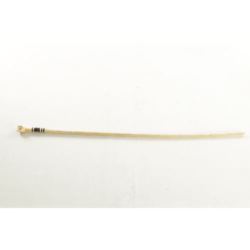 740 - A SHORT WHALEBONE WALKING STICK with ringed hardstone inset and clenched fist handle. (79cm long)