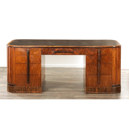 1411 - A STYLISH ART DECO WALNUT AND COROMANDEL PEDESTAL DESK with inset leather top having shaped corners ... 