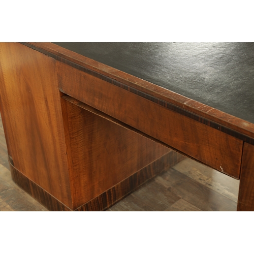 1411 - A STYLISH ART DECO WALNUT AND COROMANDEL PEDESTAL DESK with inset leather top having shaped corners ... 