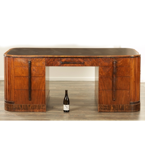 1411 - A STYLISH ART DECO WALNUT AND COROMANDEL PEDESTAL DESK with inset leather top having shaped corners ... 