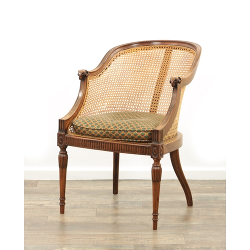 1413 - AN EARLY 20TH CENTURY ADAM STYLE MAHOGANY BERGERE CHAIR with rams head arms and leaf-carved decorati... 