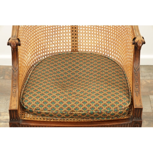 1413 - AN EARLY 20TH CENTURY ADAM STYLE MAHOGANY BERGERE CHAIR with rams head arms and leaf-carved decorati... 