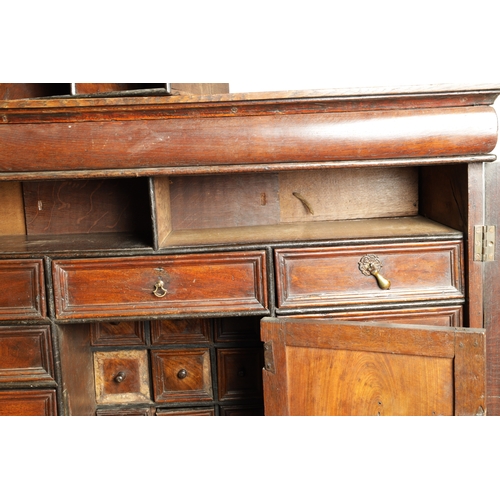 1414 - AN EARLY 18TH CENTURY OAK GEOMETRIC MOULDED CABINET ON STAND with cushion moulded cornice above a pa... 