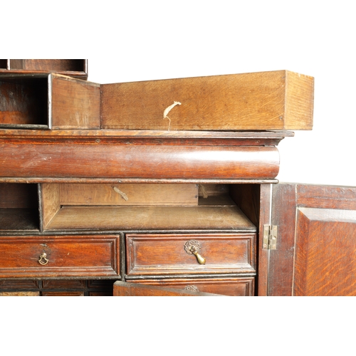 1414 - AN EARLY 18TH CENTURY OAK GEOMETRIC MOULDED CABINET ON STAND with cushion moulded cornice above a pa... 