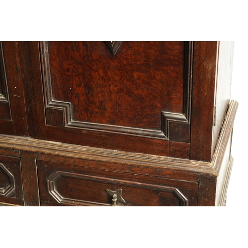 1414 - AN EARLY 18TH CENTURY OAK GEOMETRIC MOULDED CABINET ON STAND with cushion moulded cornice above a pa... 