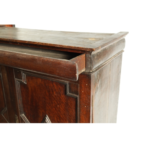 1414 - AN EARLY 18TH CENTURY OAK GEOMETRIC MOULDED CABINET ON STAND with cushion moulded cornice above a pa... 