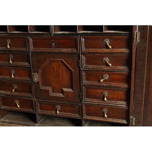 1414 - AN EARLY 18TH CENTURY OAK GEOMETRIC MOULDED CABINET ON STAND with cushion moulded cornice above a pa... 