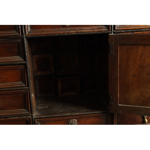 1414 - AN EARLY 18TH CENTURY OAK GEOMETRIC MOULDED CABINET ON STAND with cushion moulded cornice above a pa... 