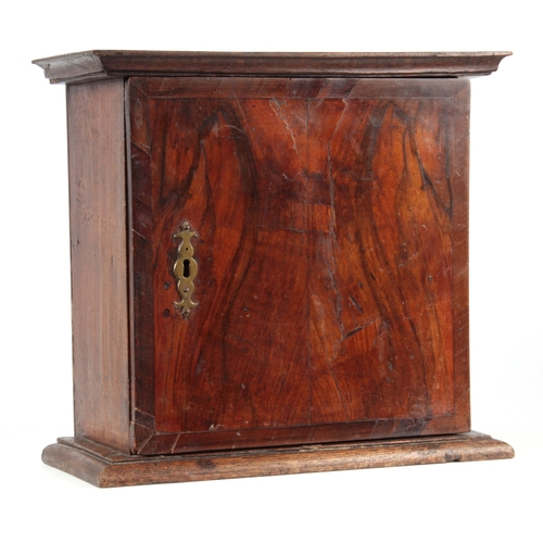 1422 - AN 18TH CENTURY OAK AND CROSSBANDED FIGURED WALNUT SPICE CABINET with hinged door enclosing a shelve... 