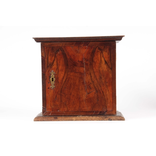 1422 - AN 18TH CENTURY OAK AND CROSSBANDED FIGURED WALNUT SPICE CABINET with hinged door enclosing a shelve... 