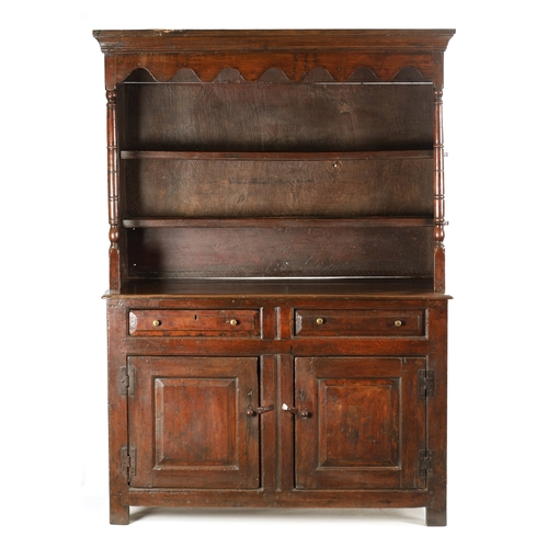 1424 - AN EARLY 18TH CENTURY OAK POSTED CANOPY DRESSER with shaped overhanging moulded top supported by rin... 