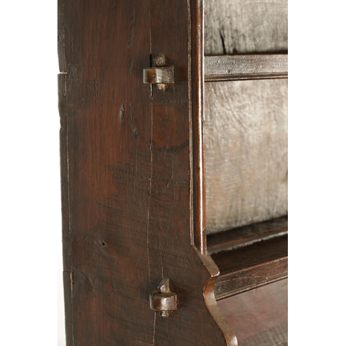 1424 - AN EARLY 18TH CENTURY OAK POSTED CANOPY DRESSER with shaped overhanging moulded top supported by rin... 