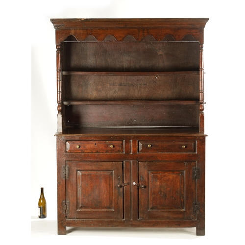 1424 - AN EARLY 18TH CENTURY OAK POSTED CANOPY DRESSER with shaped overhanging moulded top supported by rin... 