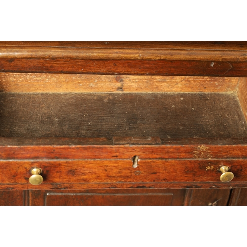 1424 - AN EARLY 18TH CENTURY OAK POSTED CANOPY DRESSER with shaped overhanging moulded top supported by rin... 