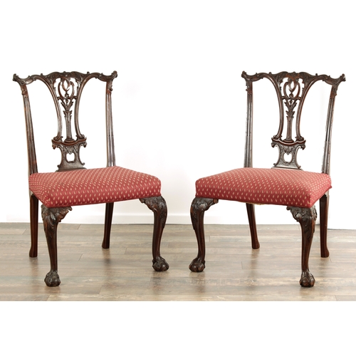 1425 - A PAIR OF GEORGE II CHIPPENDALE STYLE MAHOGANY SIDE CHAIRS with leaf-carved pierced backs, upholster... 