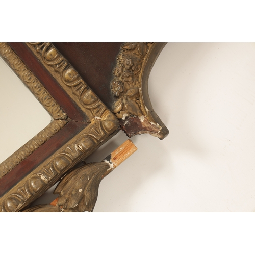 1428 - A GEORGE II MAHOGANY AND GILT GESSO HANGING MIRROR with a shaped swan-neck top and urn finial above ... 