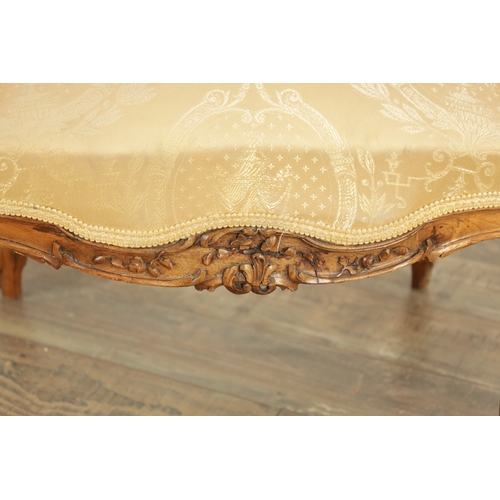 1528 - A LATE 19TH CENTURY FRENCH CARVED WALNUT UPHOLSTERED LOVE SEAT with leaf-carved rococo style frame. ... 
