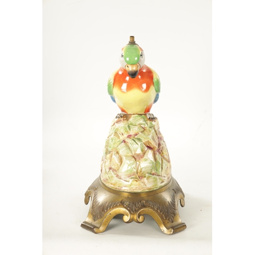 49 - AN EARLY 20TH CENTURY PORCELAIN AND CAST BRASS TABLE LAMP FORMED AS A PARROT the colourful perched b... 