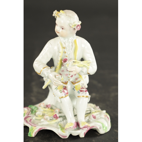 102 - A MID 18TH CENTURY DERBY PORCELAIN FIGURE of a seated young boy (11cm high)