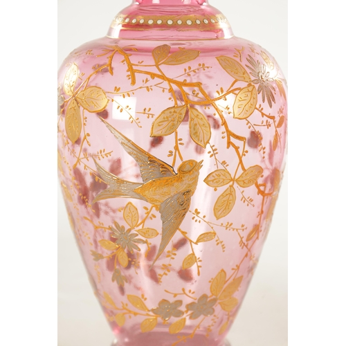 11 - A LARGE PAIR OF 19TH CENTURY CRANBERRY GLASS VASES with gilt work decoration depicting birds amongst... 