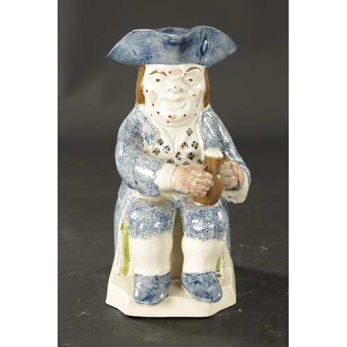 117 - AN EARLY 18TH CENTURY STAFFORDSHIRE TOBY JUG with sponge blue and Pratt colours (24cm high )