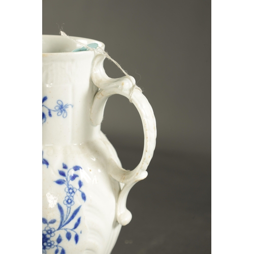 145 - A LATE 18TH CENTURY CAUGHLEY PORCELAIN JUG PAINTED WITH FLOWERING PLANTS (21cm high)