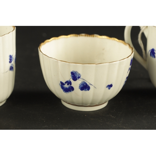 173 - A WORCESTER PORCELAIN FLUTED TRIO DECORATED WITH DRY BLUE FLOWERS CIRCA 1775 together with A SIMILAR... 