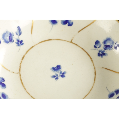 173 - A WORCESTER PORCELAIN FLUTED TRIO DECORATED WITH DRY BLUE FLOWERS CIRCA 1775 together with A SIMILAR... 