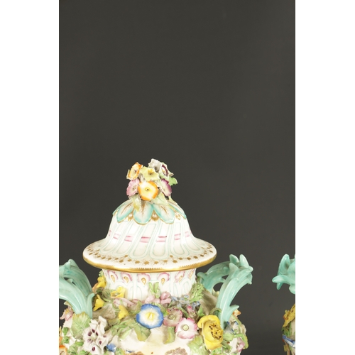 185 - A PAIR OF MID 19TH CENTURY MINTON PORCELAIN JARS AND COVERS encrusted with flowers (28cm high)