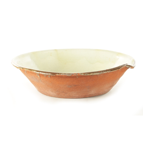 221 - A LARGE 19TH CENTURY GLAZED EARTHENWARE PANCHEON BOWL with a light green glaze and brown rim. (56cm ... 