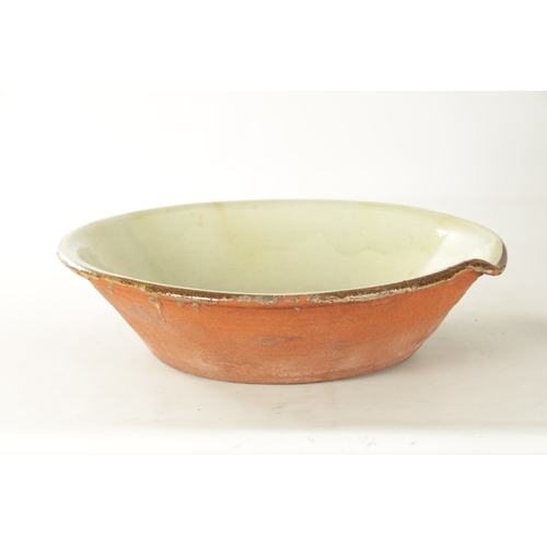 221 - A LARGE 19TH CENTURY GLAZED EARTHENWARE PANCHEON BOWL with a light green glaze and brown rim. (56cm ... 