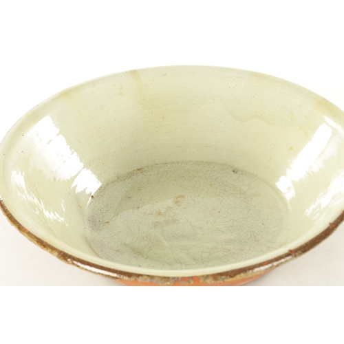 221 - A LARGE 19TH CENTURY GLAZED EARTHENWARE PANCHEON BOWL with a light green glaze and brown rim. (56cm ... 