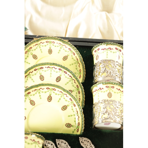 254 - A CASED ROYAL WORCESTER SIX PIECE COFFEE SERVICE WITH SILVER PLATED CUPHOLDERS AND SPOONS yellow gro... 