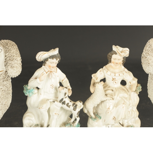 269 - TWO PAIRS OF STAFFORDSHIRE POODLES AND A PAIR OF LATE SPANIELS, and a pair of figures of a boy and g... 