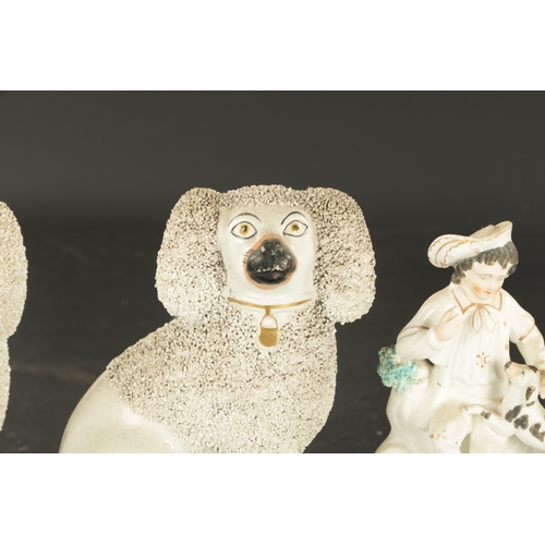 269 - TWO PAIRS OF STAFFORDSHIRE POODLES AND A PAIR OF LATE SPANIELS, and a pair of figures of a boy and g... 